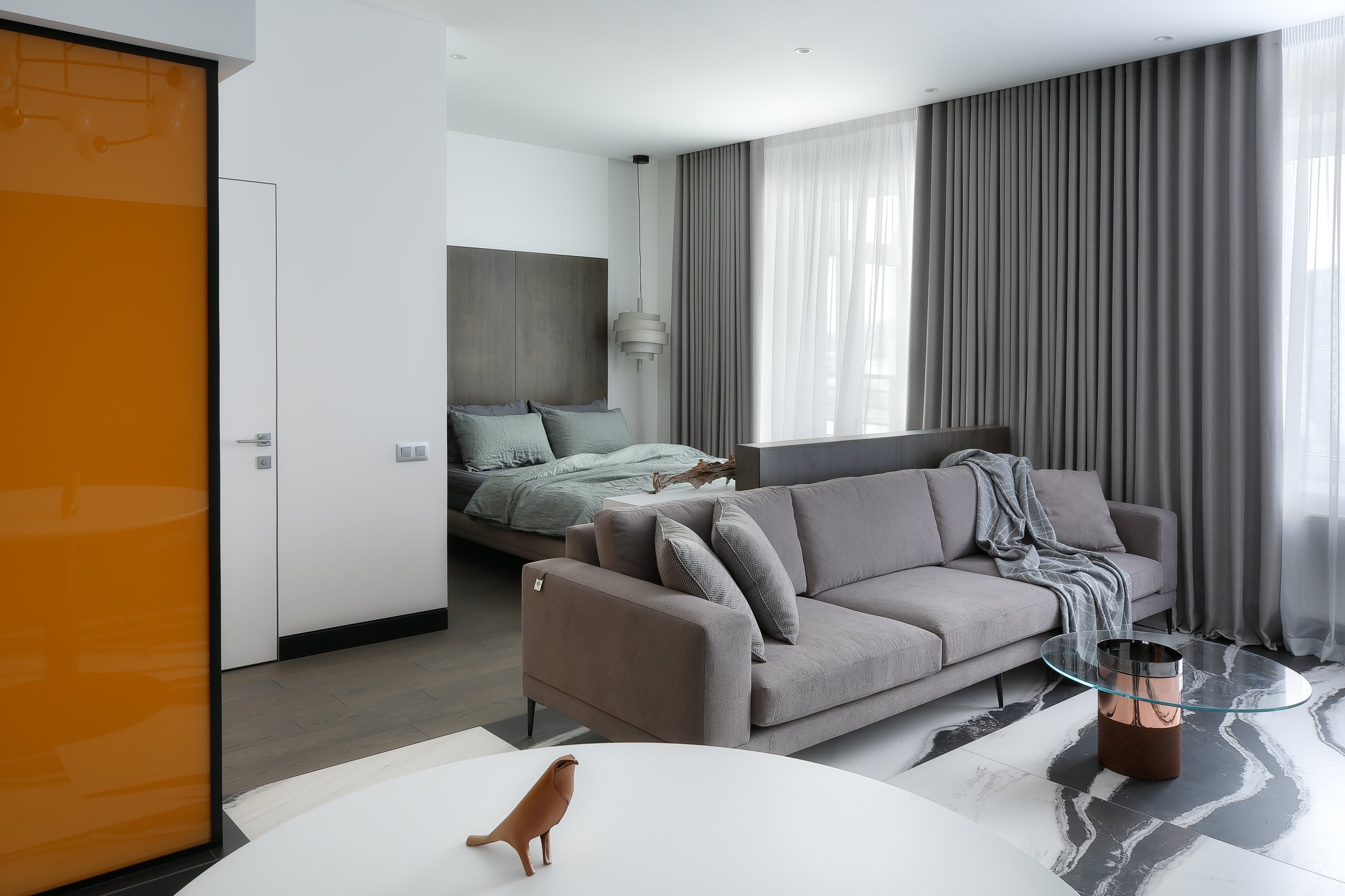 Amber sliding wardrobe doors beside the sofa.