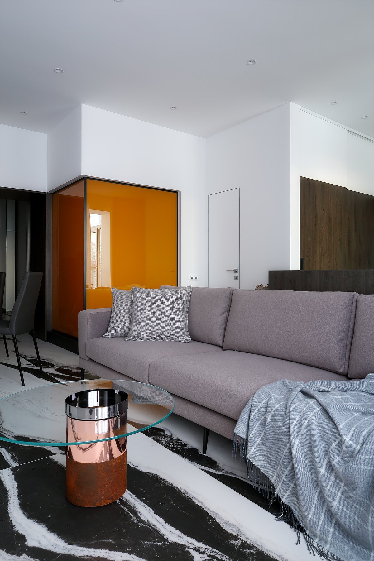 Sofa area with an amber glass accent panel.