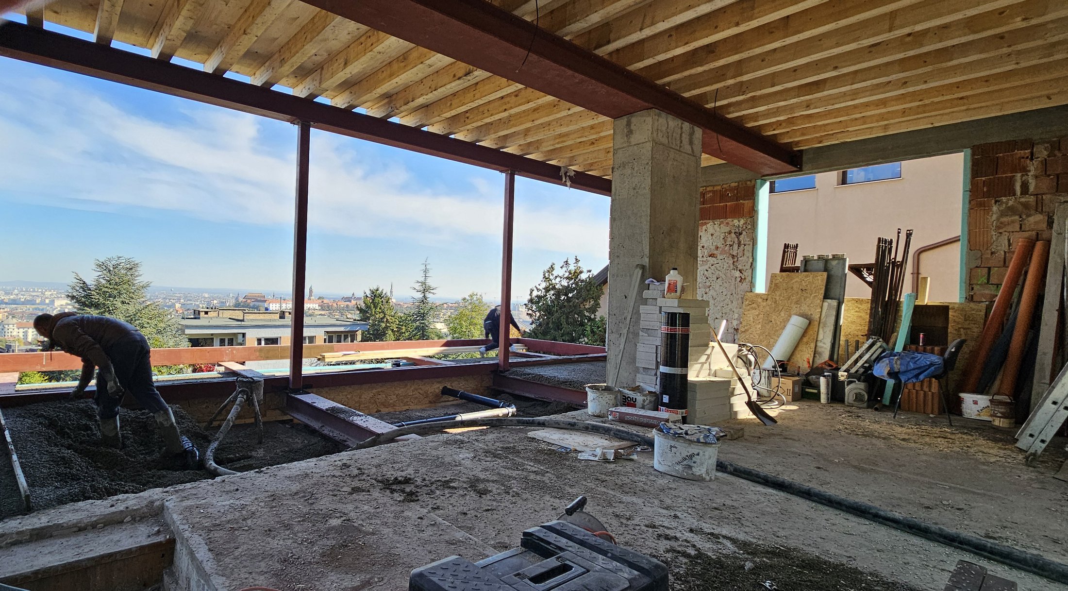 Construction site photograph showing the villa's original steel and brick structure mid renovation.
