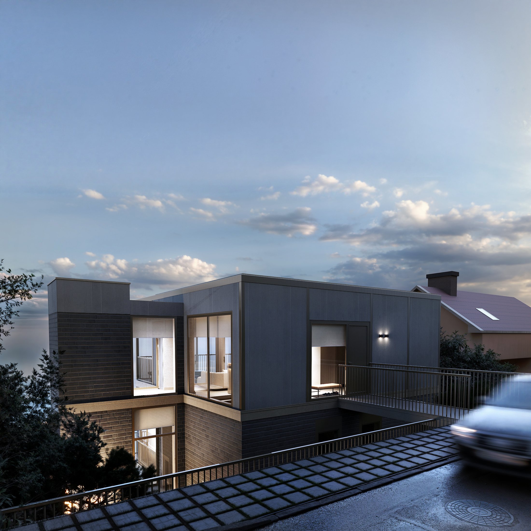 Daytime exterior view of the renovated villa against a blue sky.