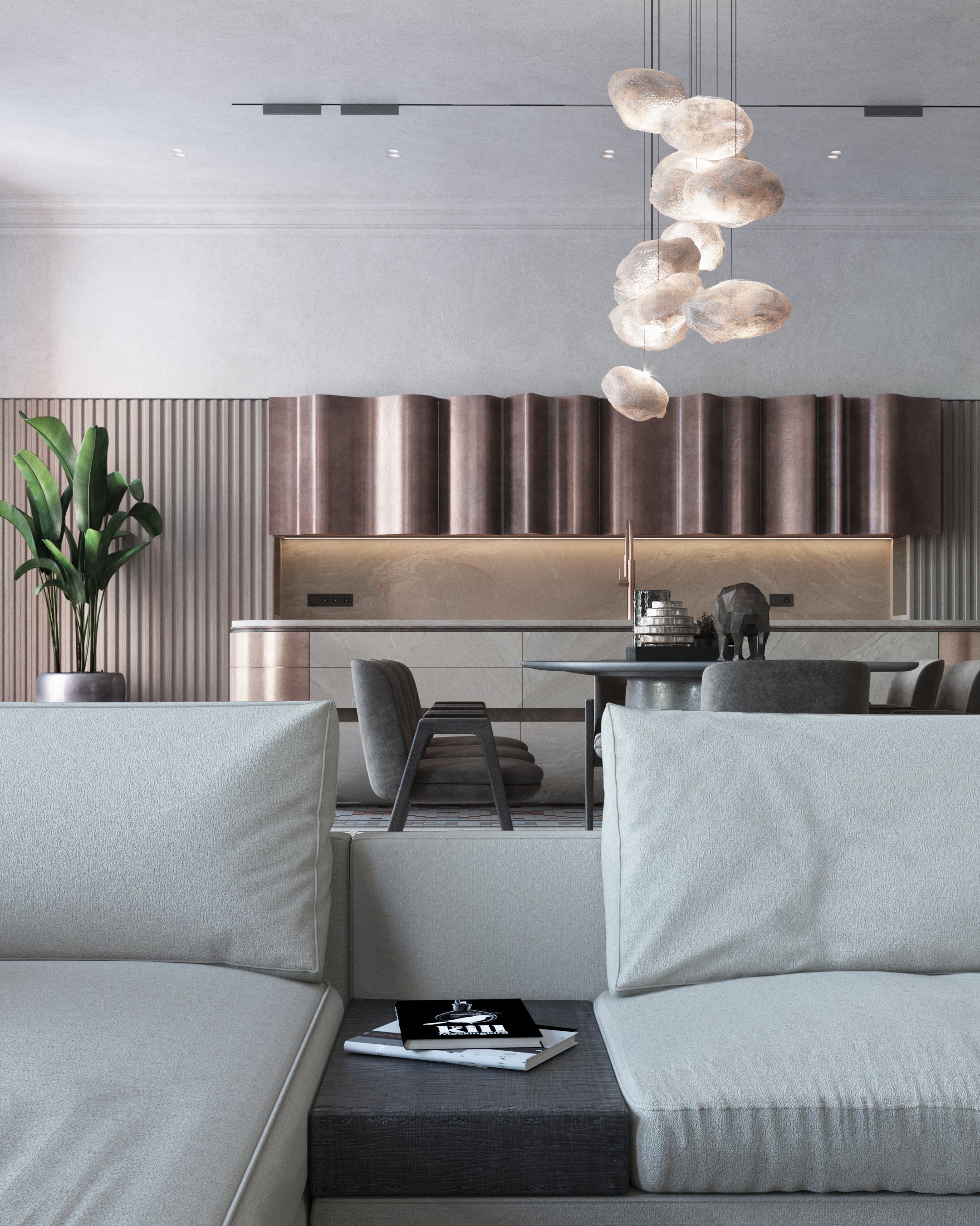 Sofa corner beneath a sculptural ceramic pendant light.