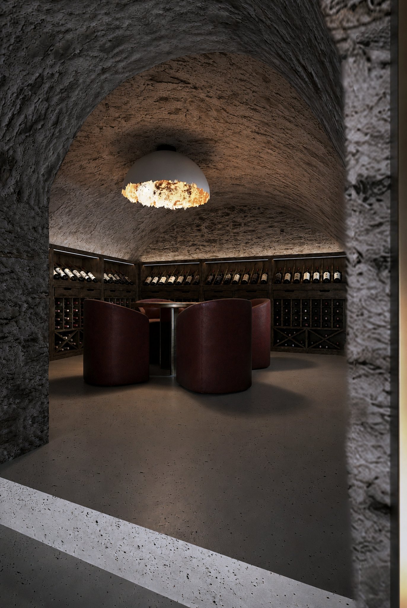 Wine cellar beneath a stone vaulted ceiling.